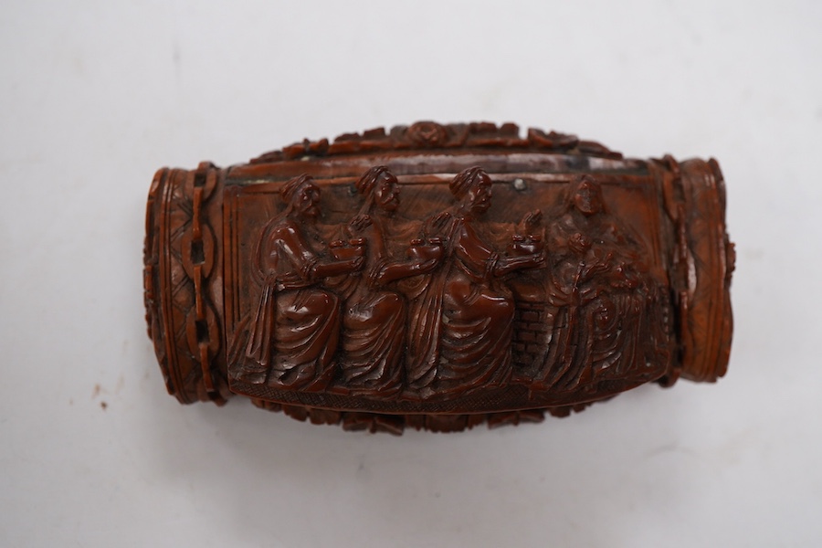 An 18th / 19th century European carved figural coquilla nut snuff box, 8.5cm wide